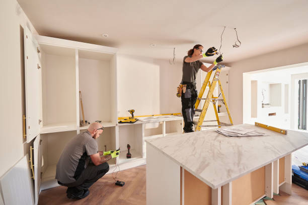 female electrician working in a kitchen remodelling